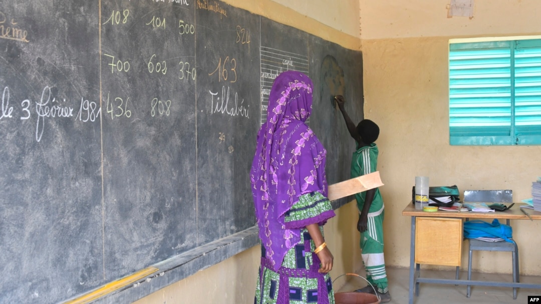 FILE - A teacher leads her classroom in a school on the outskirts of Ouallam, Niger, on Oct. 26, 2022. Africa needs to recruit at least 15 million teachers by 2030 to address a shortage in primary and secondary schools, UNESCO says.