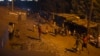 People walk back home during early evening at the Kangemi slum in Kenya's capital Nairobi, February 28, 2013.