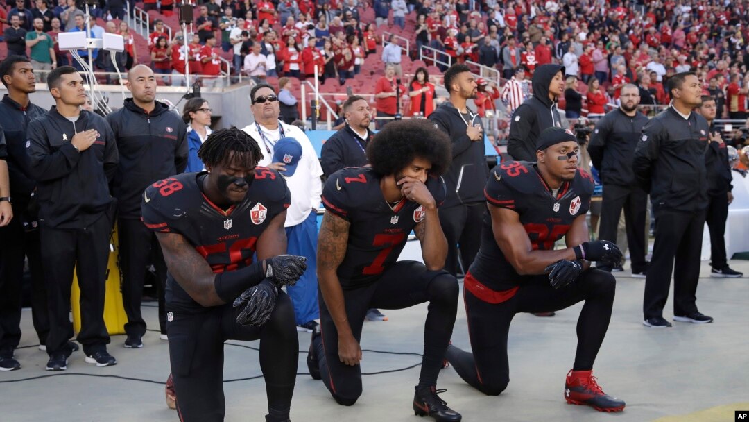 San Francisco 49ers outside linebacker Eli Harold (58), quarterback Colin Kaepernick (7) and safety Eric Reid (35) kneel during the national anthem before an NFL football game Oct. 6, 2016.