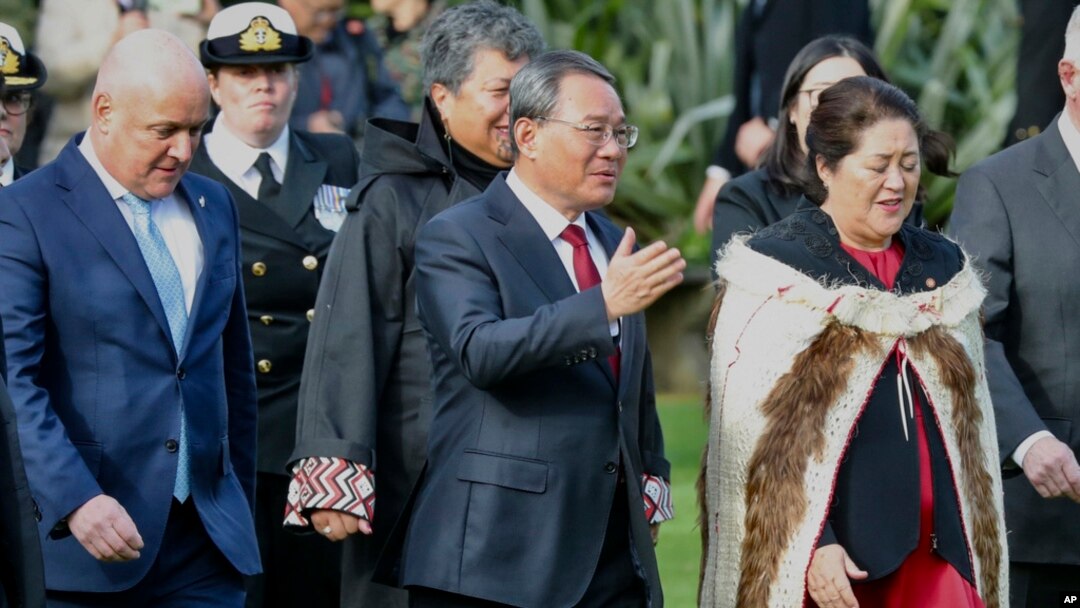 Chinese Premier Li Qiang, center, stands with New Zealand Prime Minister Christopher Luxon, left, and New Zealand Governor General Dame Cyndi Kiro during the official welcome ceremony in Wellington, New Zealand, June 13, 2024.