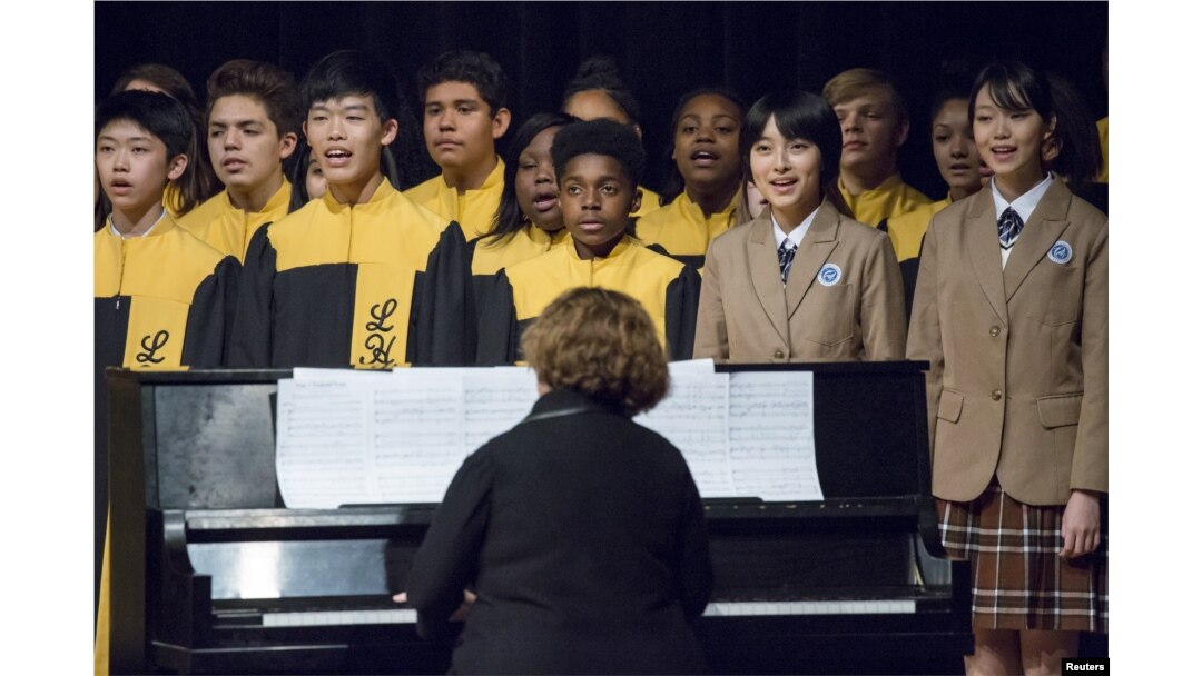 FILE - Choir students from Lincoln High School in Tacoma, Washington, sing with choir students from Tacoma's sister city, Fuzhou, during a performance for Chinese President Xi Jinping during his visit to Tacoma's Lincoln High School, Sept. 23, 2015.