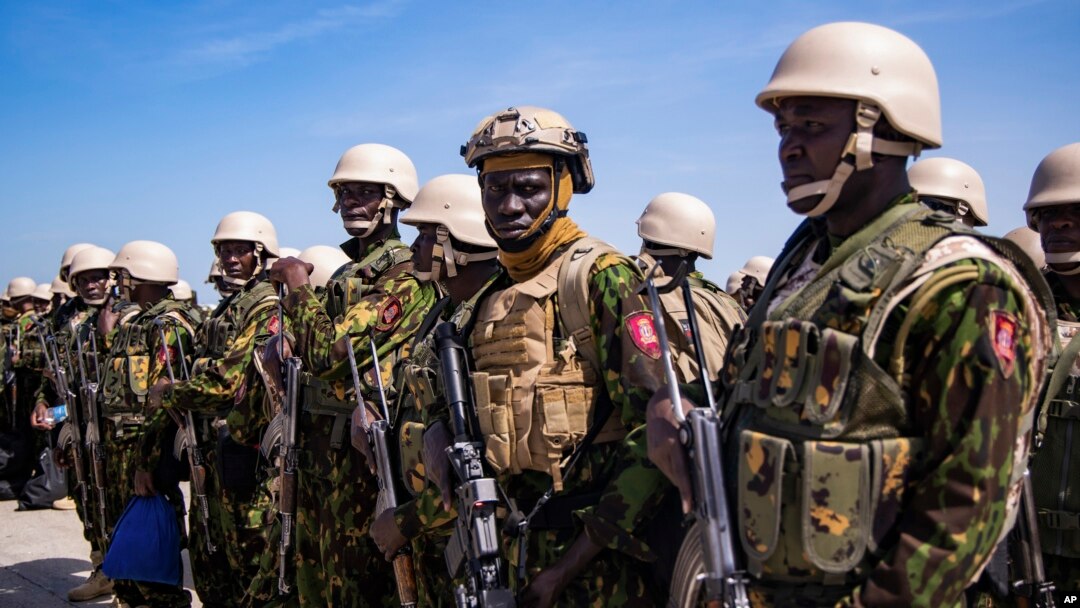 Members of a police force from Kenya stand on the tarmac of Toussaint Louverture International Airport after landing in Port-au-Prince, Haiti, June 25, 2024. 