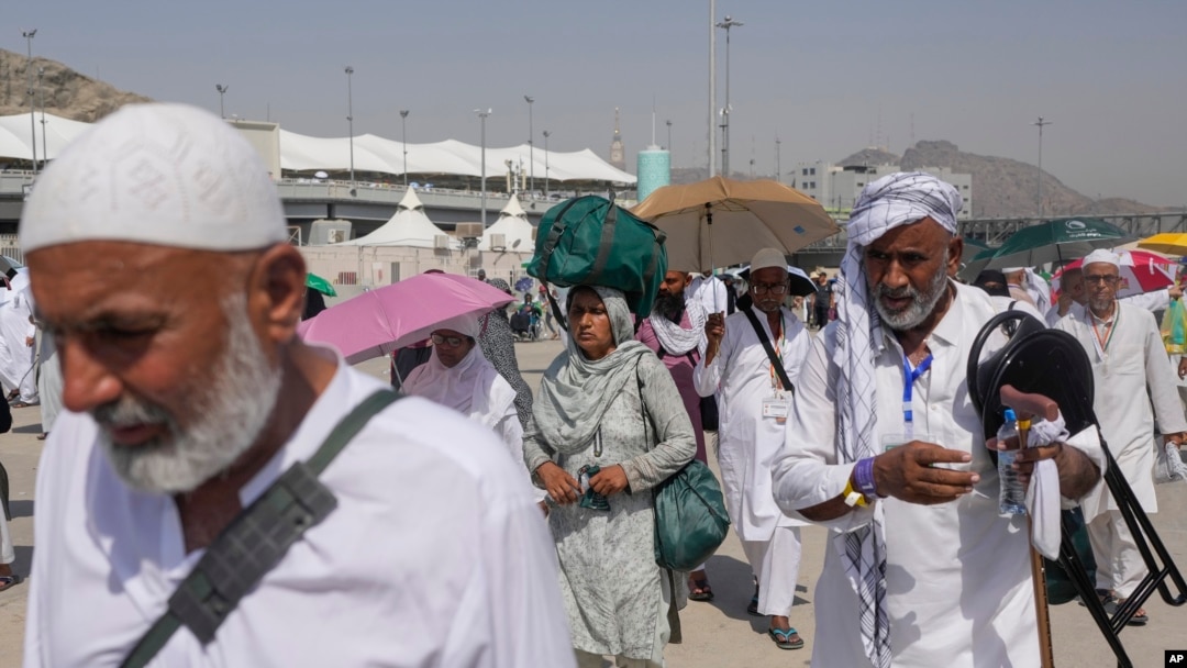 FILE - Muslim pilgrims arrive to cast stones at pillars in the symbolic stoning of the devil, the last rite of the annual hajj, in Mina, near the holy city of Mecca, Saudi Arabia, June 18, 2024. 