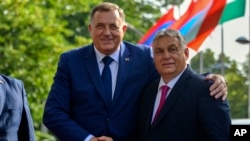 Bosnian Serb leader Milorad Dodik, left, poses with Hungarian Prime Minister Viktor Orban during a welcome ceremony in Banja Luka, Bosnia northwest of Sarajevo, June 22, 2023.