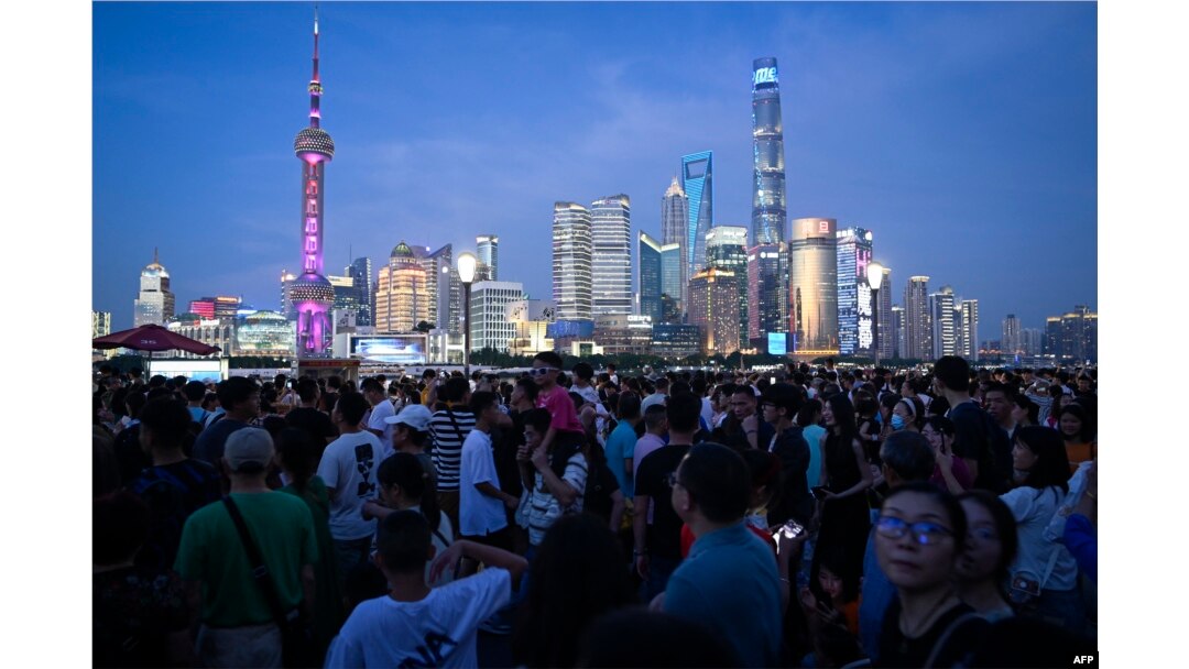 Tourists visit the Bund waterfront area in Shanghai, China, July 5, 2023.
