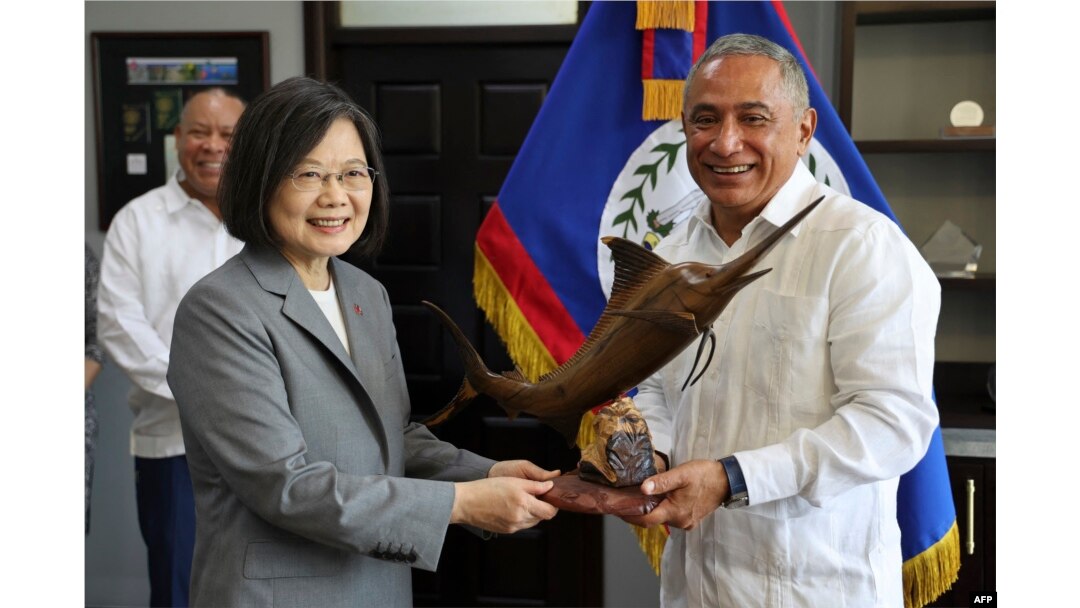 FILE - Taiwan's President Tsai Ing-wen, left, receives a gift from Belize's Prime Minister John Briceño at the Foreign Ministry in Belmopan on April 3, 2023. (Photo by Government of Belize Press Office/AFP)