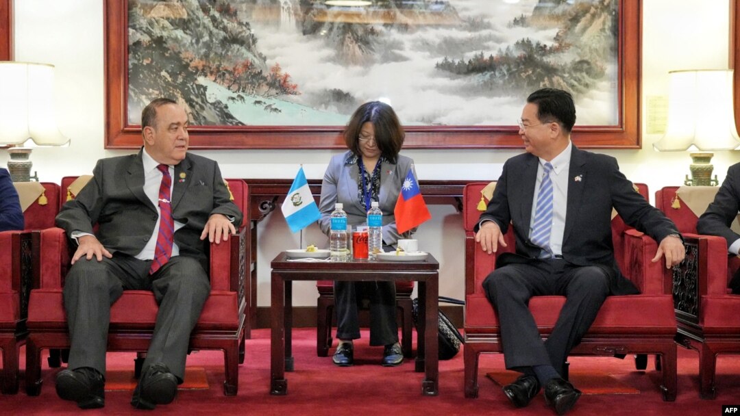 Guatemala's President Alejandro Giammattei, left, meets with Taiwan Foreign Minister Joseph Wu after his arrival to Taoyuan International Airport, in Taoyuan, Taiwan, April 23, 2023. (Taiwan Ministry of Foreign Affairs/Handout via AFP)