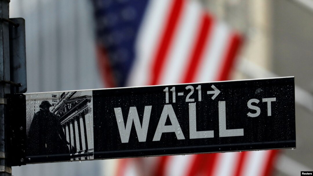 FILE - A sign for Wall Street outside the New York Stock Exchange in Manhattan in New York City, New York, Oct. 26, 2020. 