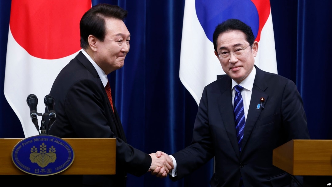 FILE - South Korea President Yoon Suk Yeol, left, and Japan Prime Minister Fumio Kishida shake hands during a joint news conference in Tokyo, March 16, 2023. Kishida will see Yoon again when he visits Seoul on Sunday. 