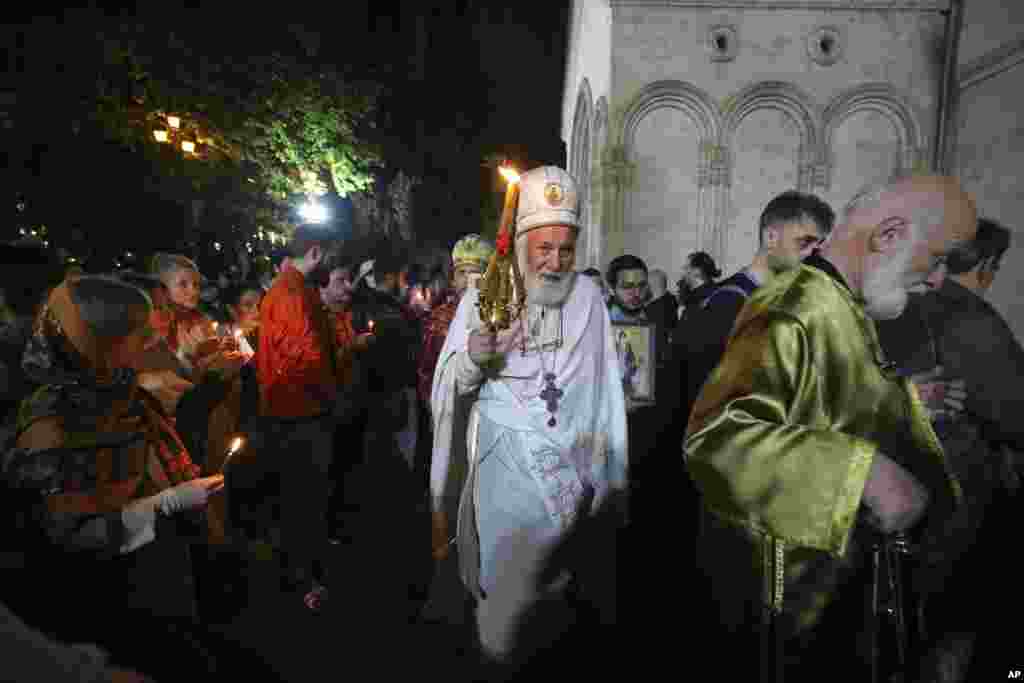 A Georgian Orthodox Church priest leads a religious service celebrating Orthodox Easter at the Trinity cathedral in Tbilisi, Georgia, May 5, 2024.