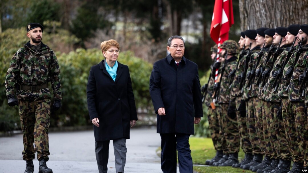 Swiss President Viola Amherd, left, and Prime Minister of the People's Republic of China, Li Qiang, inspect the guard of honor during an official visit in Kehrsatz, near Switzerland's administrative capital Bern, Jan. 15, 2024.