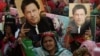 Supporters of Pakistan's former prime minister Imran Khan carry placards displaying a portrait of Khan during a protest in Karachi, March 19, 2023, demanding the release of party workers arrested in recent police clashes.
