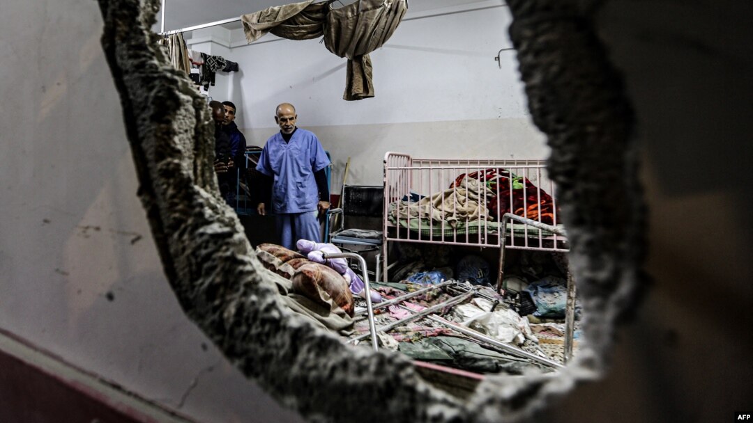 FILE - People inspect the damage in a room following Israeli bombardment at Nasser hospital in Khan Yunis in the southern Gaza Strip on Dec. 17, 2023.