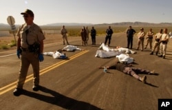 FILE - Protesters opposed to a nuclear storage facility and weapons testing lie down at the Nevada Test Site at Mercury, Nevada, May 11, 2003. Advocates have long been trying to bring awareness to the lingering effects of nuclear fallout.