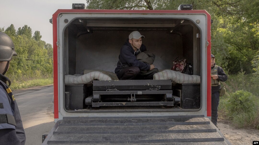 Oleksandr, an evacuee from the front-line village of Lyptsi arrives in an armored vehicle at a checkpoint, outside Kharkiv, on May 13, 2024.