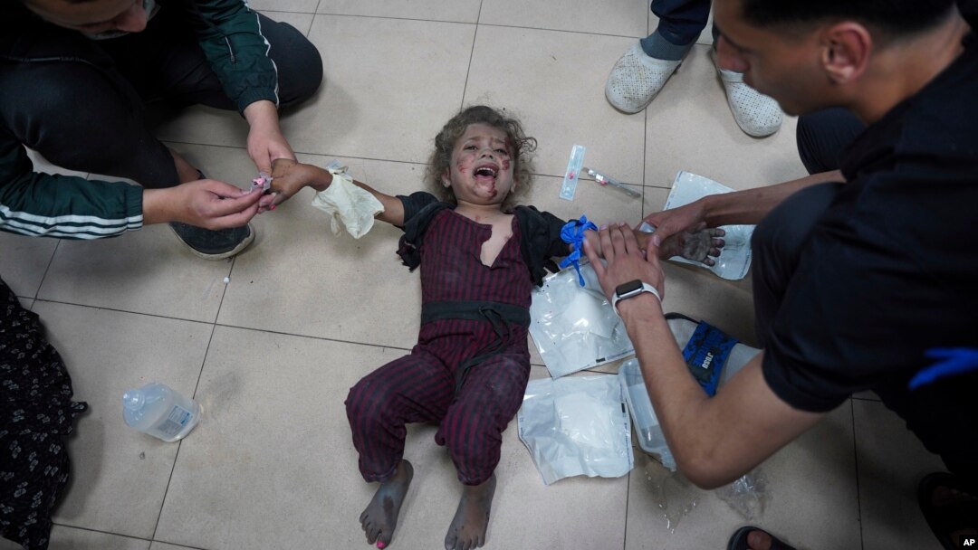 FILE - Palestinian medics treat a wounded baby at Al Aqsa Hospital in Deir al-Balah, Gaza Strip, May 11, 2024. U.S. officials are working to get upward of 20 American doctors and medical workers who The Intercept reports are trapped in Gaza.  