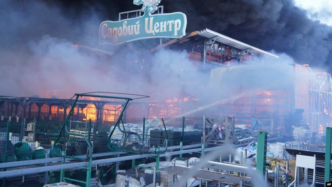 Firefighters put out a fire after two guided bombs hit a large construction supplies store in Kharkiv, Ukraine, May 25, 2024. 