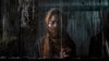A woman weaves a traditional Afghan carpet at a factory in Kabul, Afghanistan, March 6, 2023.