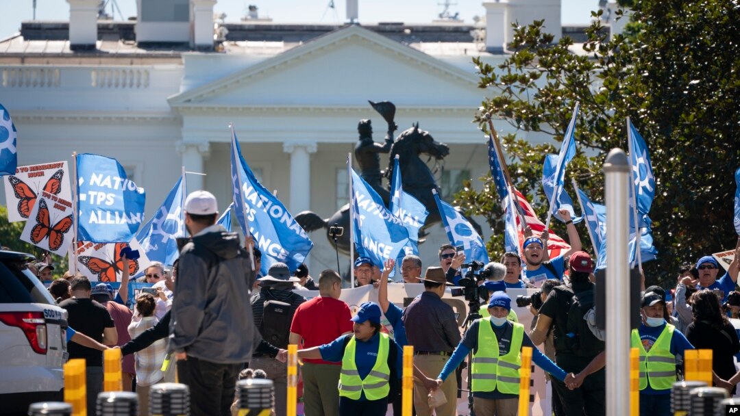 FILE - People protest for an extension and expansion of the Temporary Protected Status (TPS) program, Friday, Sept. 23, 2022, at Lafayette Park by the White House in Washington.