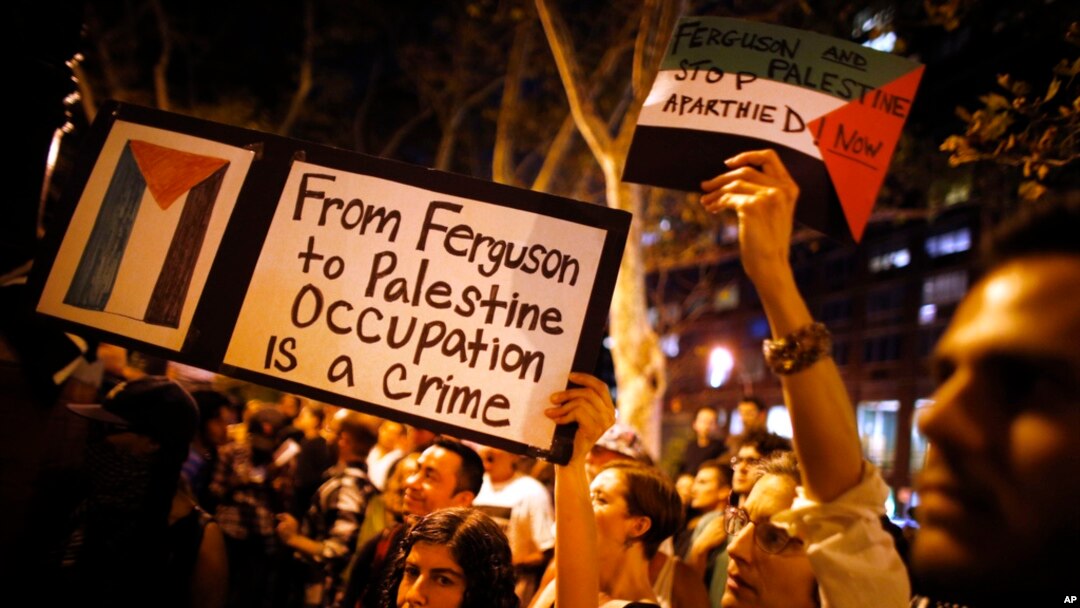 FILE - Demonstrators from a nearby pro-Palestinian rally join a protest in New York on Aug. 20, 2014, against the police shooting death of Michael Brown in Ferguson, Mo.