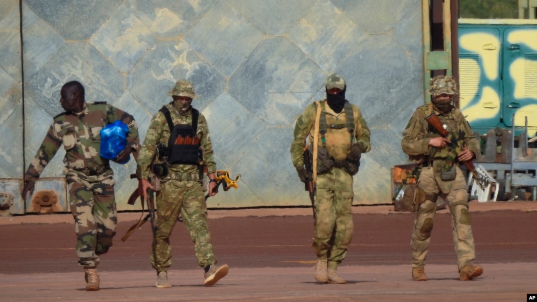 FILE - This undated photo provided by the French military shows three Russian mercenaries in northern Mali. Mali and its neighbors have long battled an Islamic extremist insurgency. Ruling juntas have turned to Russia's mercenary units for security assistance.