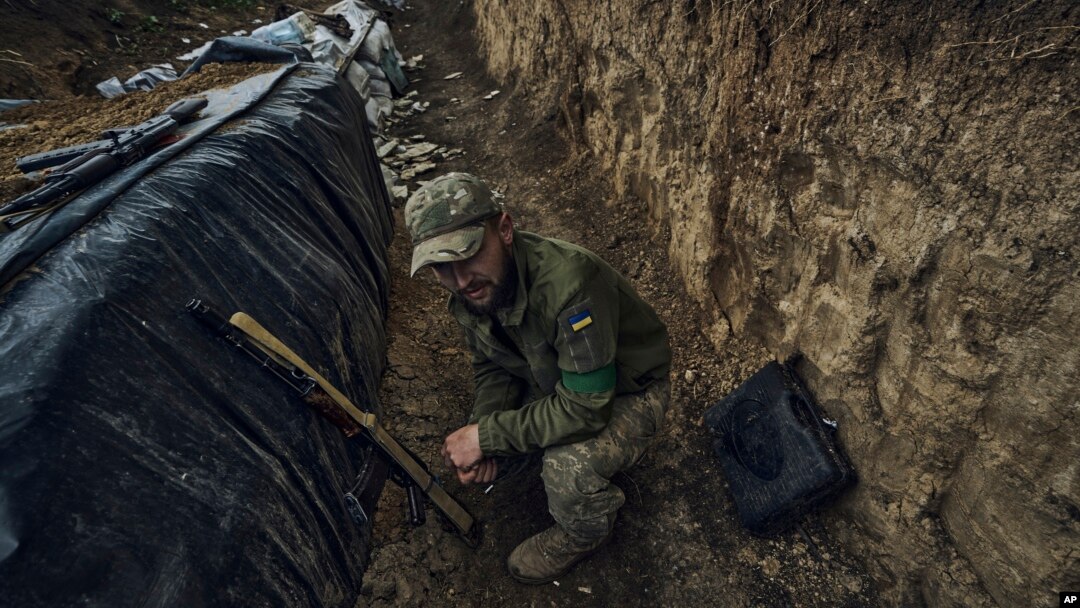 A Ukrainian soldier sits in a trench at the frontline near Bakhmut in the Donetsk region, Ukraine, May 22, 2023. 