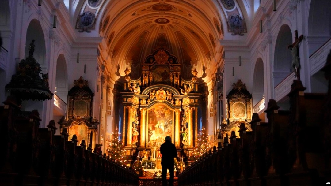 A man walks through the St. Anna basilica in Altoetting, some 90 kilometers east of Munich near Marktl, the birthplace of Pope emeritus Benedict XVI, Germany, Dec. 29, 2022. 