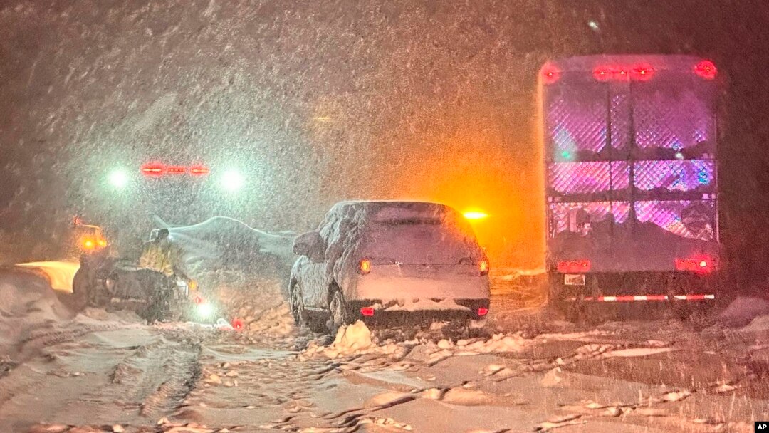 In this photo, taken Dec. 31, 2022, and released by California Highway Patrol, vehicles are stranded along Interstate 80 at the Nevada State line near Colfax, California.