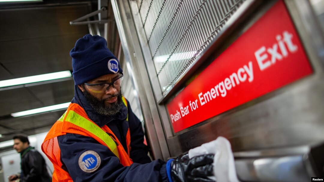 MTA worker disinfects a subway station in the Manhattan borough of New York City, March 4, 2020. 