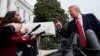 FILE - President Donald Trump points to CNN's Jim Acosta, a White House aide takes the microphone from him during as a news conference in the East Room of the White House, Nov. 7, 2018, in Washington. 