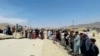 Hundreds of people gather outside the international airport in Kabul, Afghanistan, Aug. 17, 2021.
