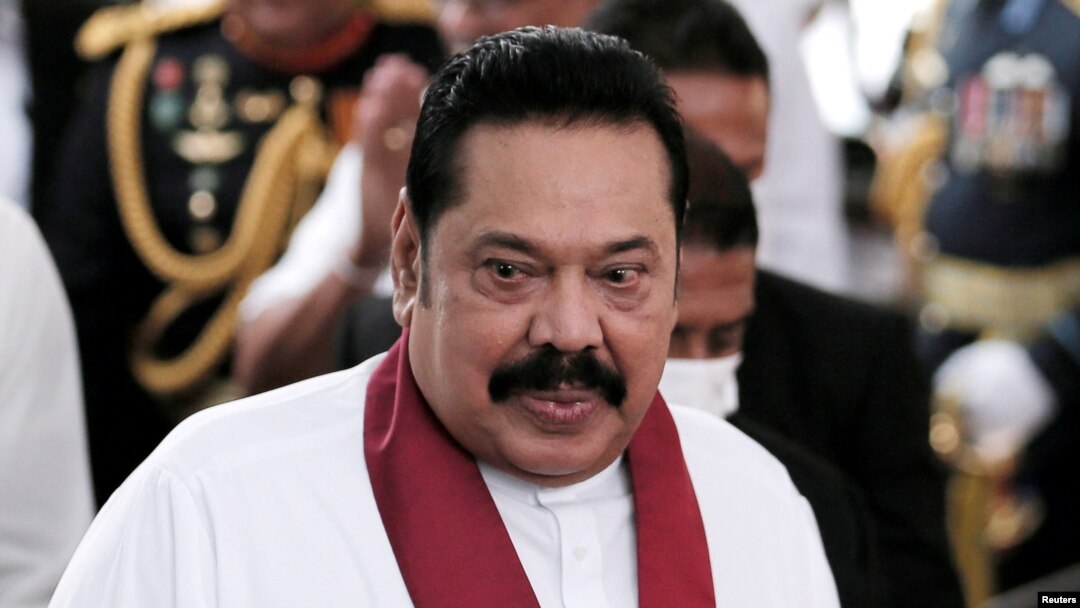 FILE - FILE PHOTO: Sri Lanka's Prime Minister Mahinda Rajapaksa reacts during his swearing in ceremony as the new Prime Minister, at Kelaniya Buddhist temple in Colombo, Sri Lanka, Aug. 9, 2020. 