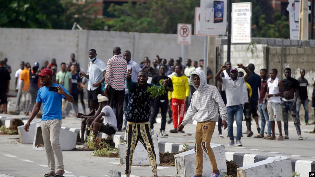 FILE - Young people protest at the Lekki Toll Gate in Lagos, Nigeria, Oct. 21, 2020. The Lekki gate was the site where demonstrators were fired upon earlier in the week in an escalation that sparked global outrage.