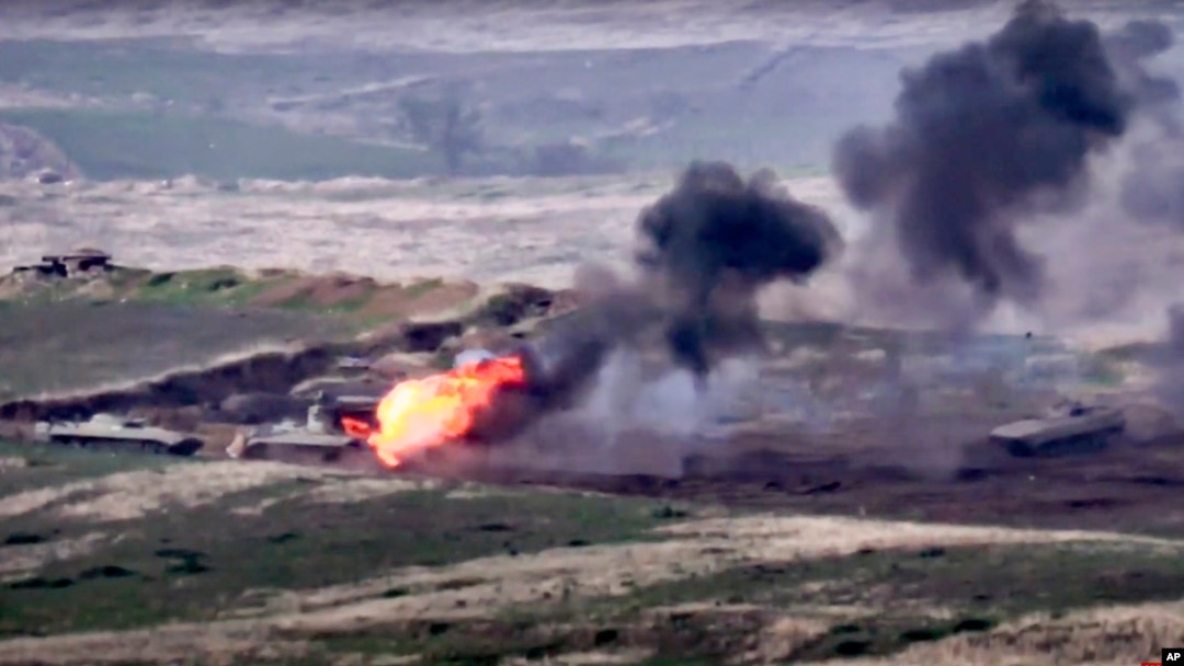 In this image taken from a footage released by Armenian Defense Ministry on Sept. 27, 2020, Armenian forces destroy an Azerbaijani military vehicle at the contact line of the self-proclaimed Republic of Nagorno-Karabakh, Azerbaijan. 
