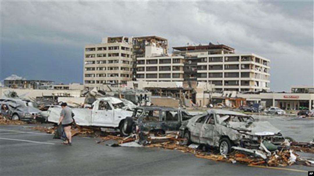 Damaged vehicles litter the parking lot of St. John's Hospital in Joplin, Missouri, after a tornado hit the Missouri city on Sunday, May 22, 2011