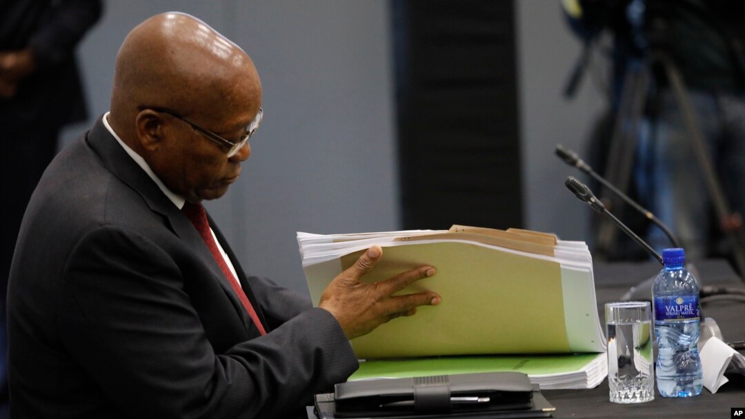 Former South African president Jacob Zuma leafs through documents as he testifies before a state commission probing wide-ranging allegations of corruption in government and state-owned companies, in Johannesburg, South Africa, July 17, 2019.