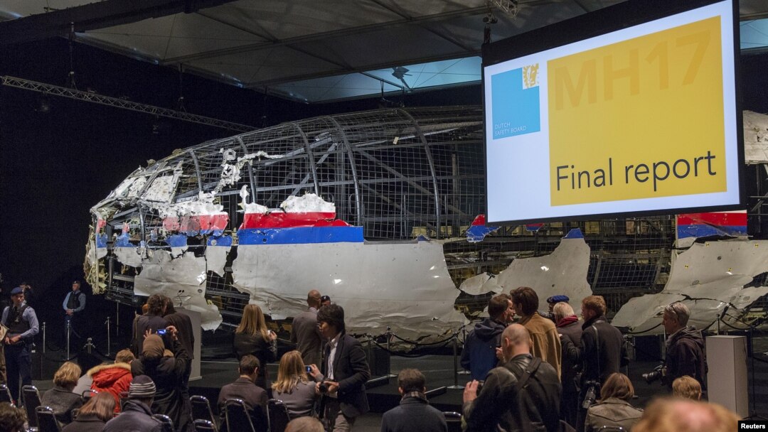 The reconstructed airplane serves as a backdrop during the presentation of the final report into the July 2014 crash of Malaysia Airlines flight MH17, in Gilze Rijen, the Netherlands, October 13, 2015.