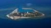FILE - The Vietnamese-claimed Southwest Cay island in the Spratly island group is seen from a Philippine Air Force C-130 transport plane.