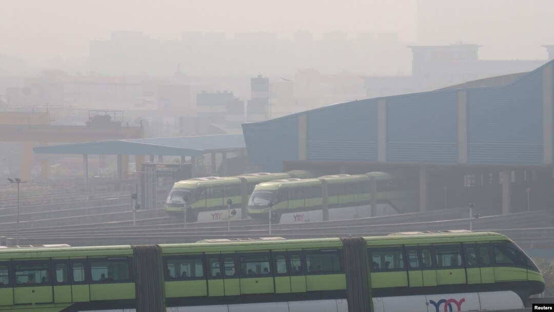 FILE - People commute in a Mumbai Monorail on a smoggy morning in Mumbai, India, Jan. 7, 2021.