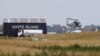 A Navy helicopter hovers at Whakatane Airport, as the recovery operation to return the victims of the Dec. 9 volcano eruption continues off the coast of Whakatane New Zealand, Dec. 13, 2019.