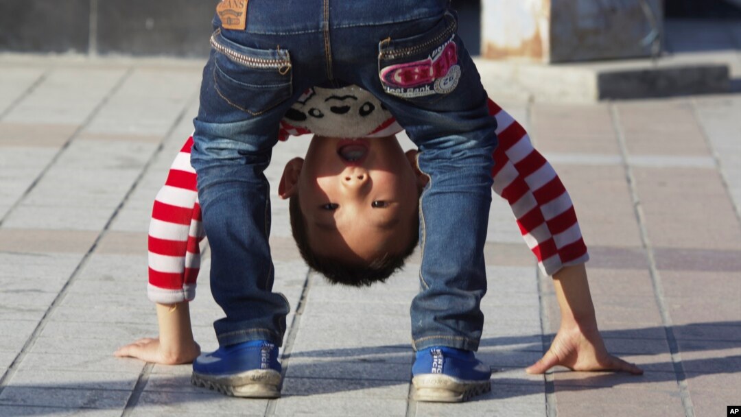 FILE - A child bends over in a public park in Yinchuan in northwestern China's Ningxia Hui autonomous region, Oct. 8, 2015. China this week officially ended its three-decade old one-child policy.