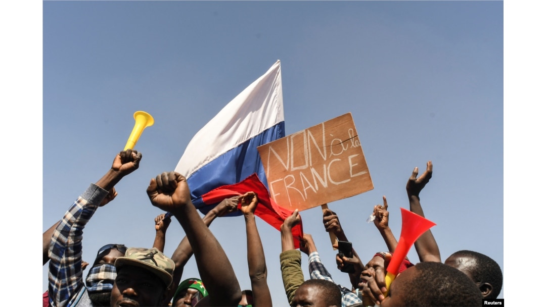 FILE - People gather in support of a coup that ousted President Roch Kabore, dissolved government, suspended the constitution and closed borders in Burkina Faso, Ouagadougou, Jan. 25, 2022.