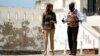 U.S. first lady Melania Trump walks through a courtyard during a visit to Cape Coast castle, Ghana, October 3, 2018. 