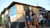 FILE - Residents of Cidade de Deus slum receive food from members of the Institute doAcao, which was produced at the Santuario de Nossa Senhora de Fatima, amid the COVID-19 outbreak, in Rio de Janeiro, Brazil, June 24, 2021.