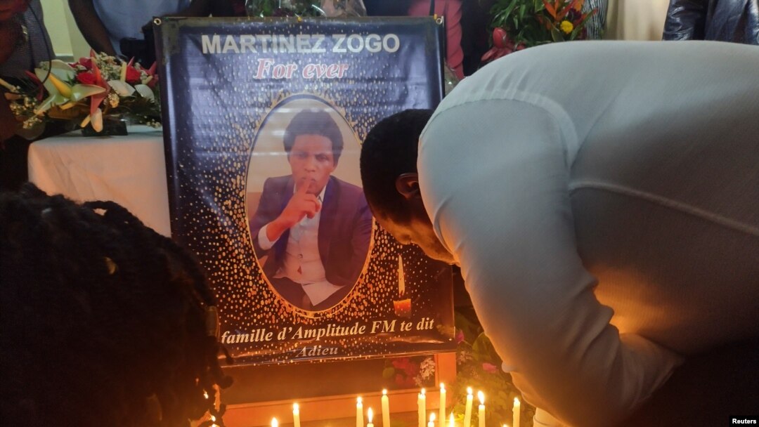 FILE - Journalists pay their last respects to colleague Martinez Zogo, who was found dead after being abducted, in Yaounde, Cameroon, Jan. 23, 2023.