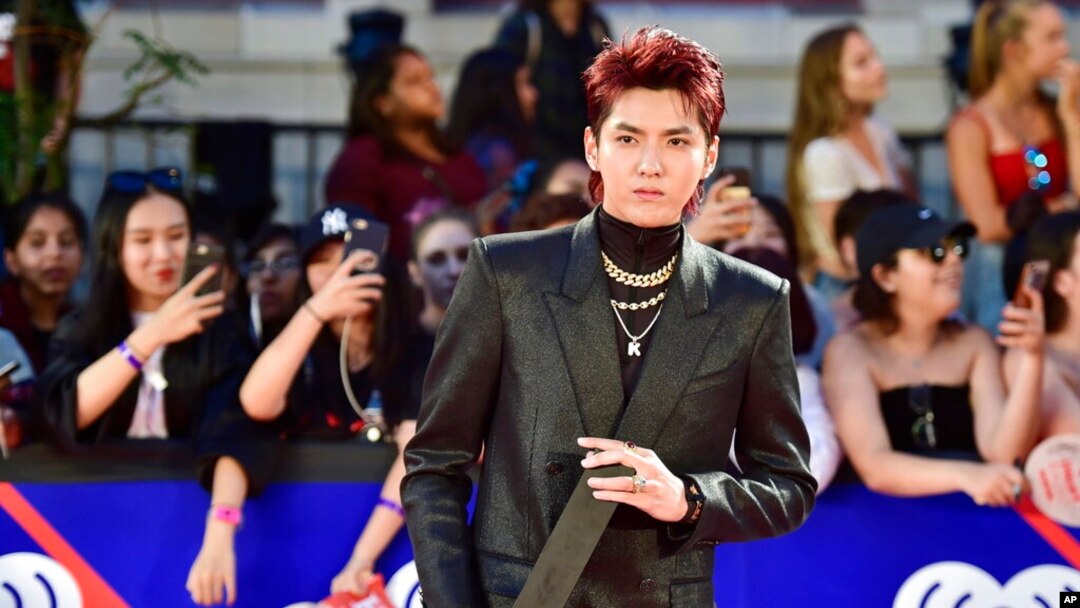 FILE - Singer Kris Wu celebrates his award for Fan Fave New Artist on the red carpet at the iHeartRadio MMVAs in Toronto on Aug. 26, 2018.