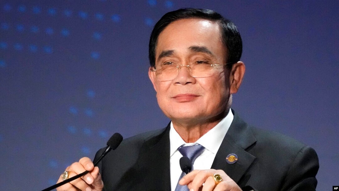 FILE - Thailand's Prime Minister Prayuth Chan-ocha adjusts microphones at a conference in Tokyo on May 26, 2022.