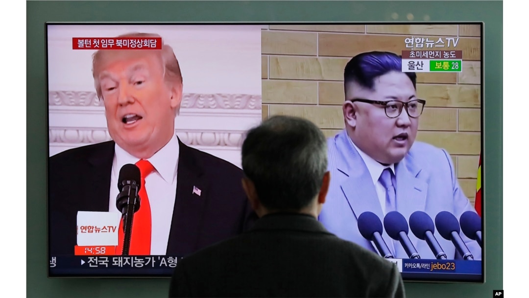FILE - A man watches a TV screen showing file footage of U.S. President Donald Trump and North Korean leader Kim Jong Un during a news program at the Seoul Railway Station in Seoul, South Korea, March 27, 2018.