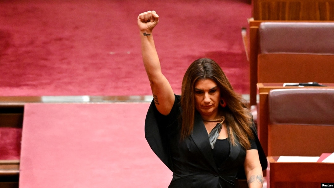 FILE - Indigenous Australian parliamentarian Lidia Thorpe raises her fist during her swearing-in ceremony in the Senate chamber at Parliament House in Canberra, Australia, Aug. 1, 2022. 