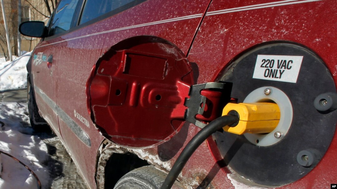 FILE - An electric car is charged in Montpelier, Vt., Jan. 18, 2013. With gas prices low, consumers are buying more trucks and SUVs and fewer fuel-efficient vehicles. That makes it harder to reach fleetwide gas mileage targets.